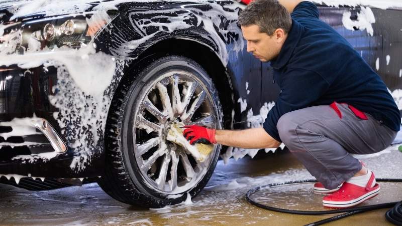 guy washes the car exterior, 