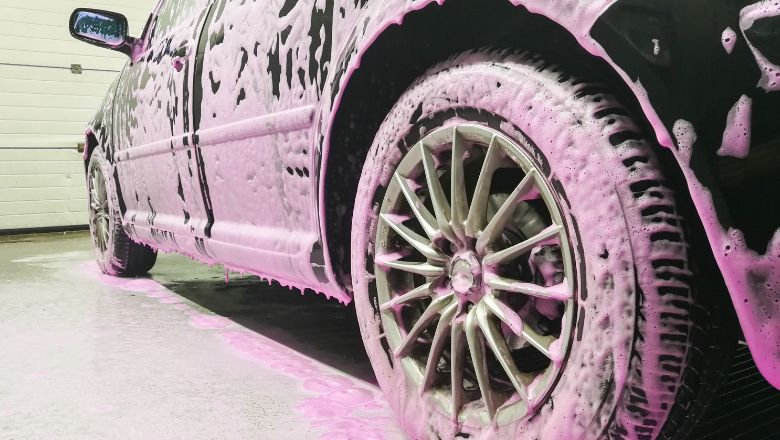 pink snow foam applied to the car
