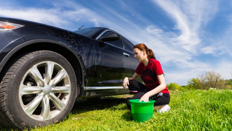 woman washing car with one bucket 