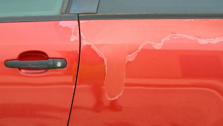 paint peeling off a red vehicle