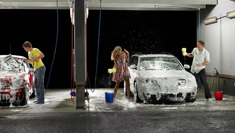 people washing their cars at night and having fun